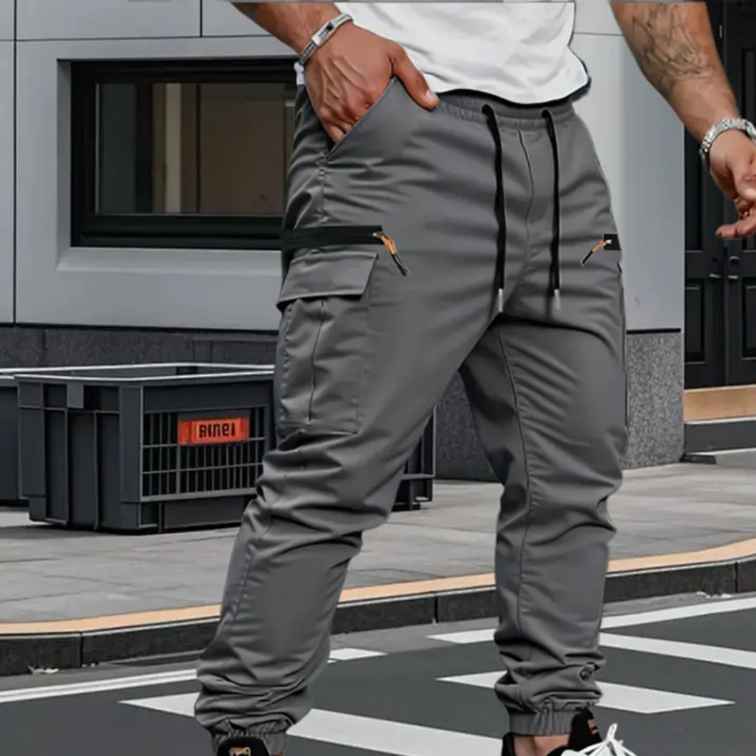 Man wearing grey cargo joggers with zip pockets