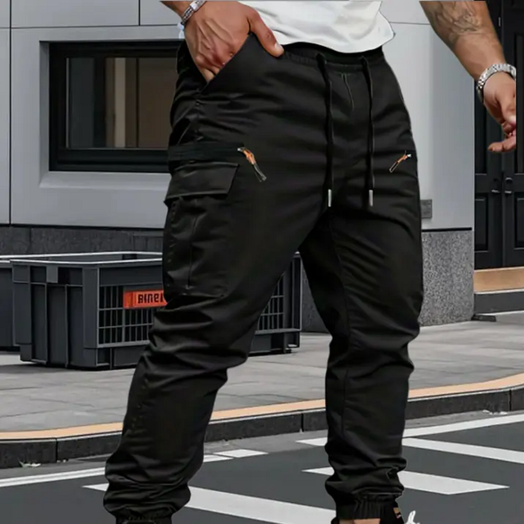 Man wearing black cargo joggers with white trainers