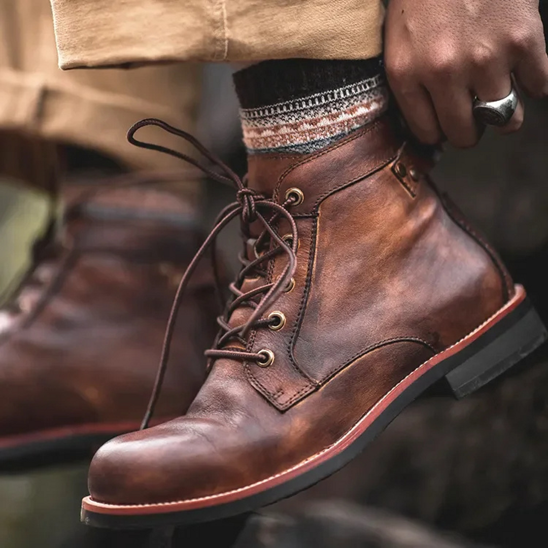 Man lacing brown casual ankle boots