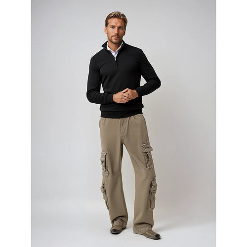 Man wearing a black half-zip pullover with chinos
