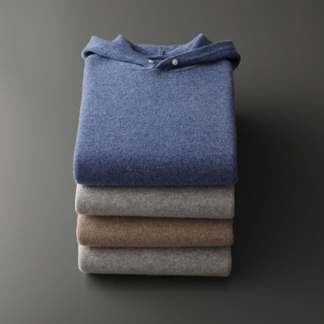 Stack of knit hoodies in blue, grey and beige