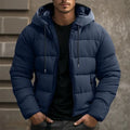 Man wearing a navy hooded quilted puffer jacket