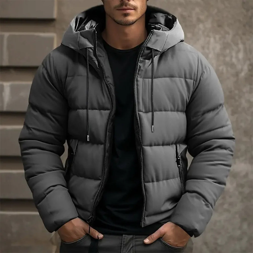 Man wearing a grey quilted puffer jacket