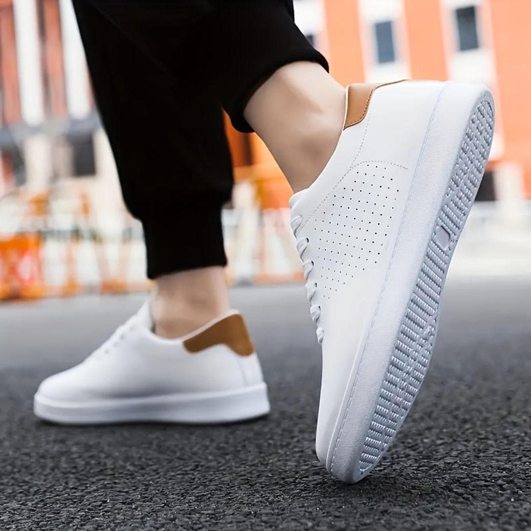 Men's perforated low top sneakers in white, worn