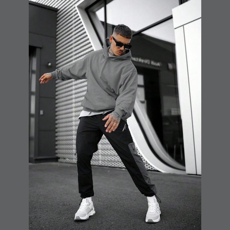 Man wearing the grey hoodie in the city