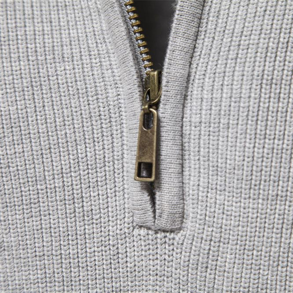 Close-up of the zip and ribbed knit on the men's half-zip sweater