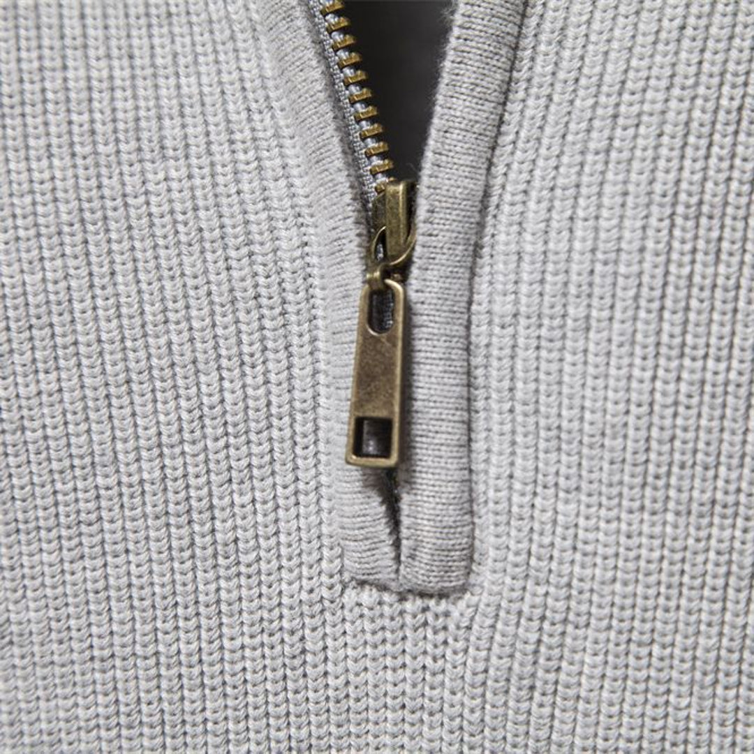 Close-up of the zip and ribbed knit on the men's half-zip sweater