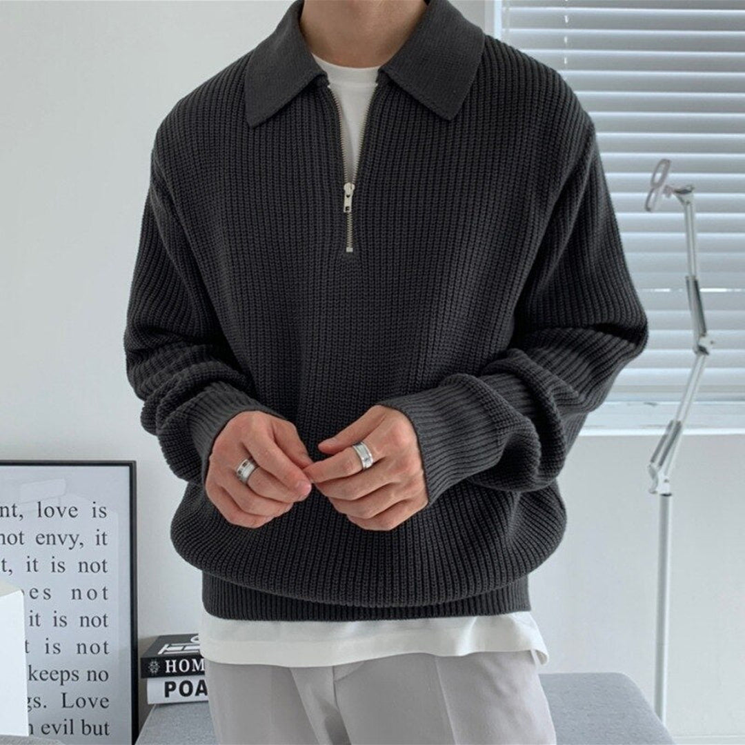Man wearing a black textured knit polo collar sweater