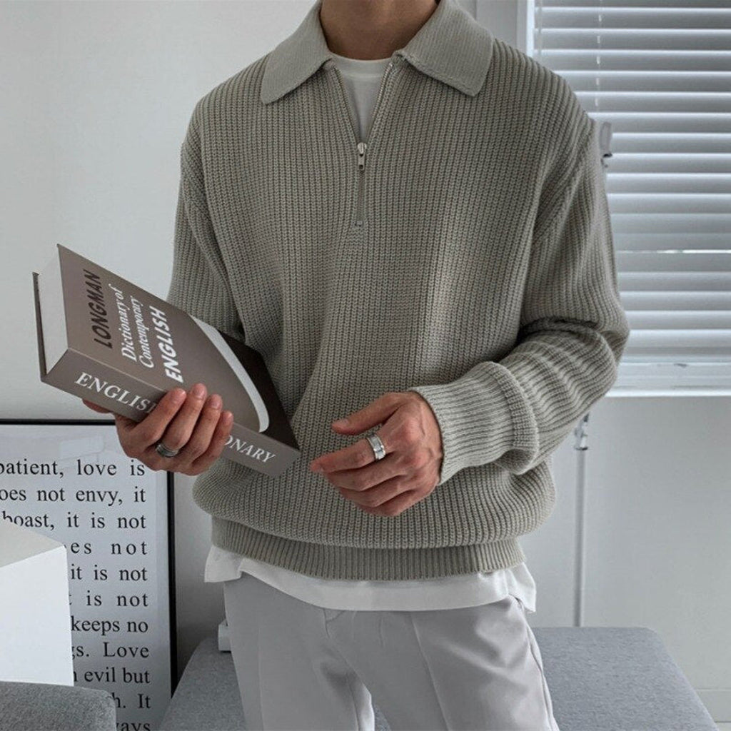 Man wearing a grey half-zip polo sweater