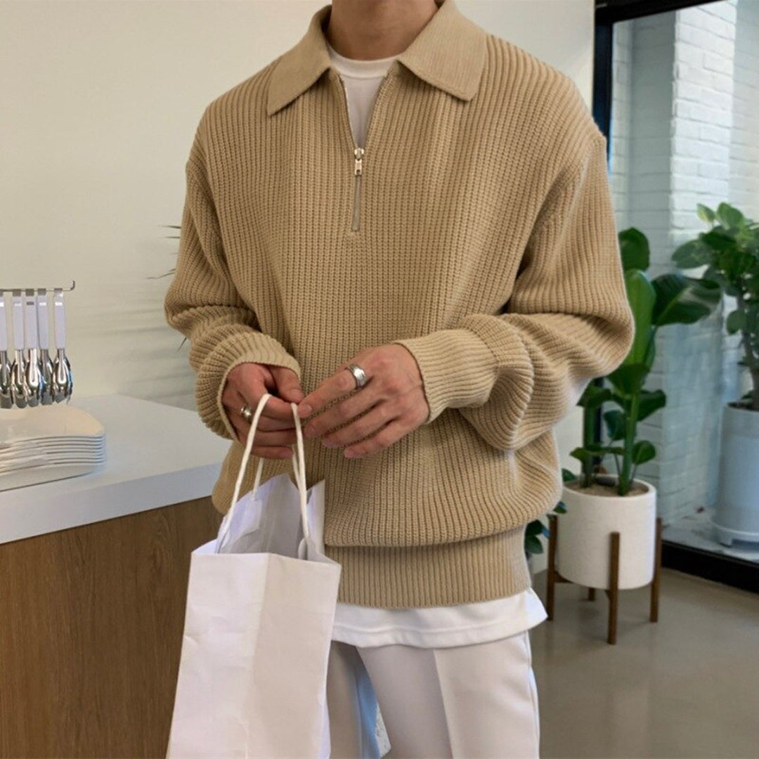 Man wearing a beige textured knit sweater with polo collar