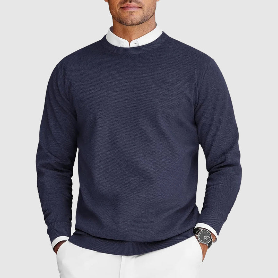 Man wearing a navy crew neck knit sweater