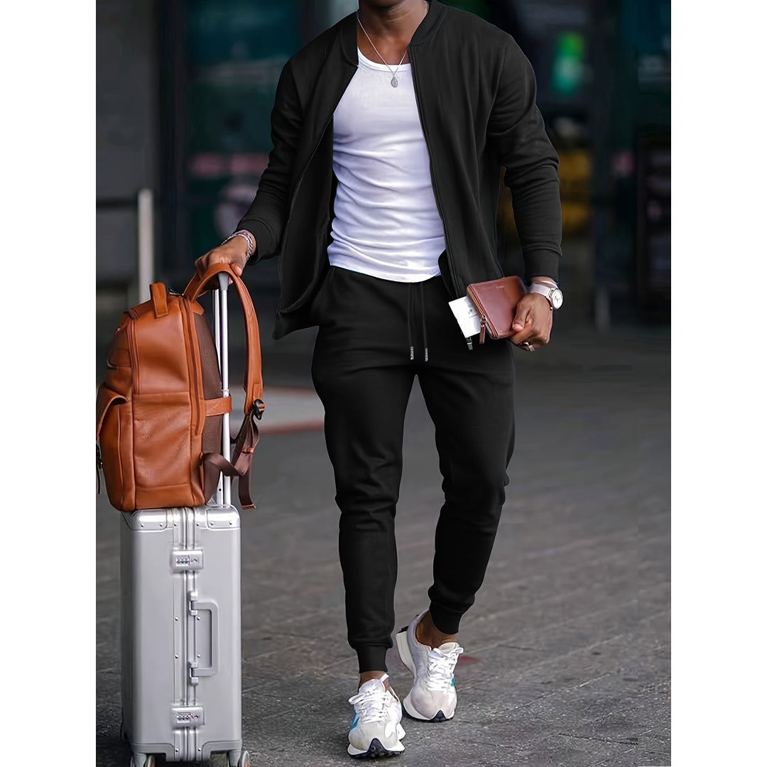 Man wearing a black zip jacket and jogger tracksuit with a suitcase