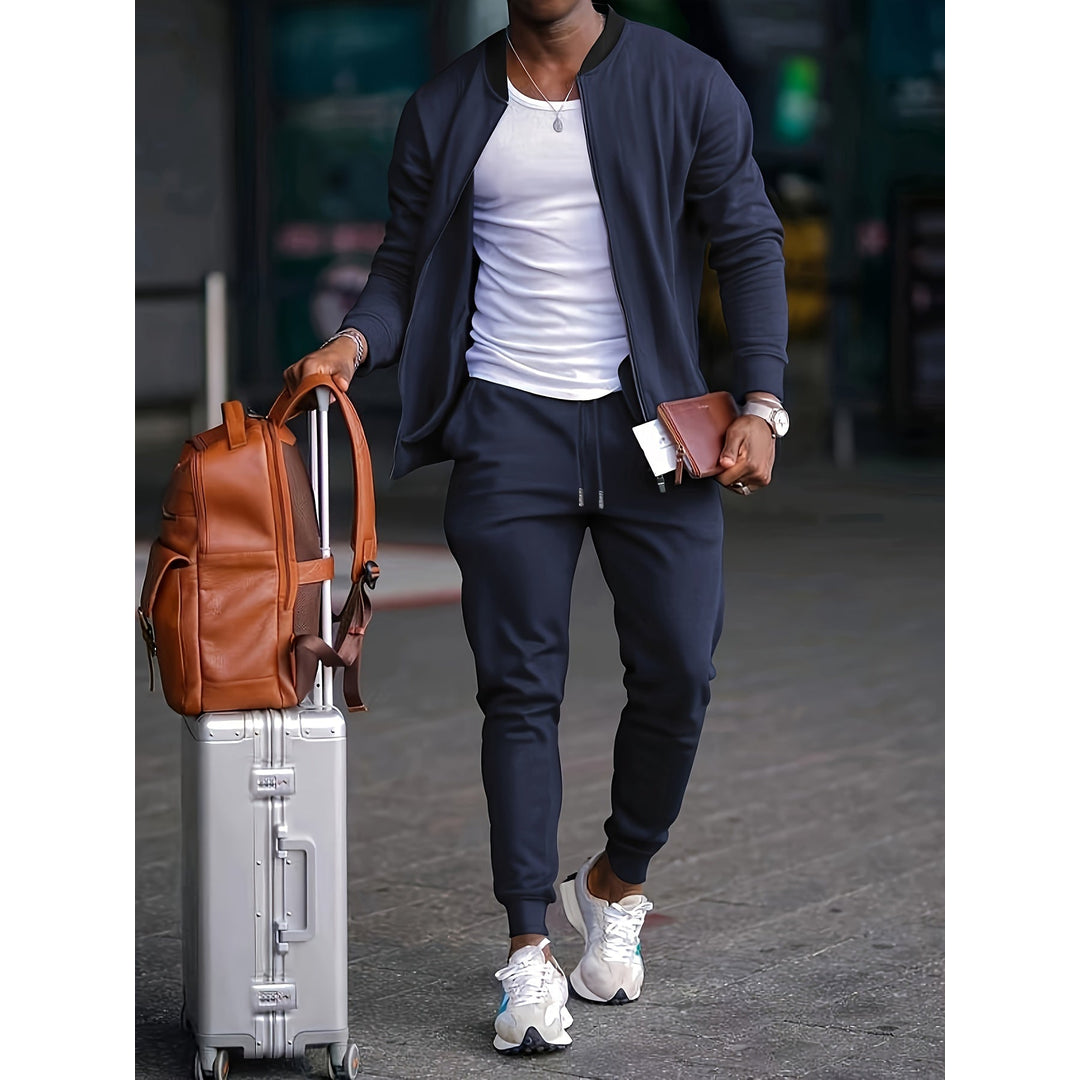 Man wearing a navy two-piece tracksuit