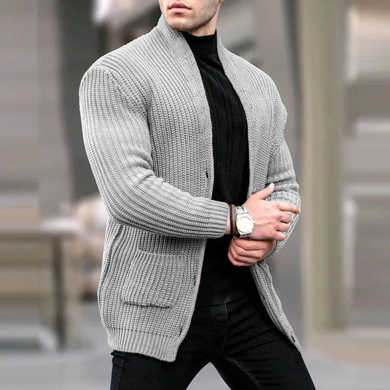 Man wearing light grey chunky knit cardigan with pockets