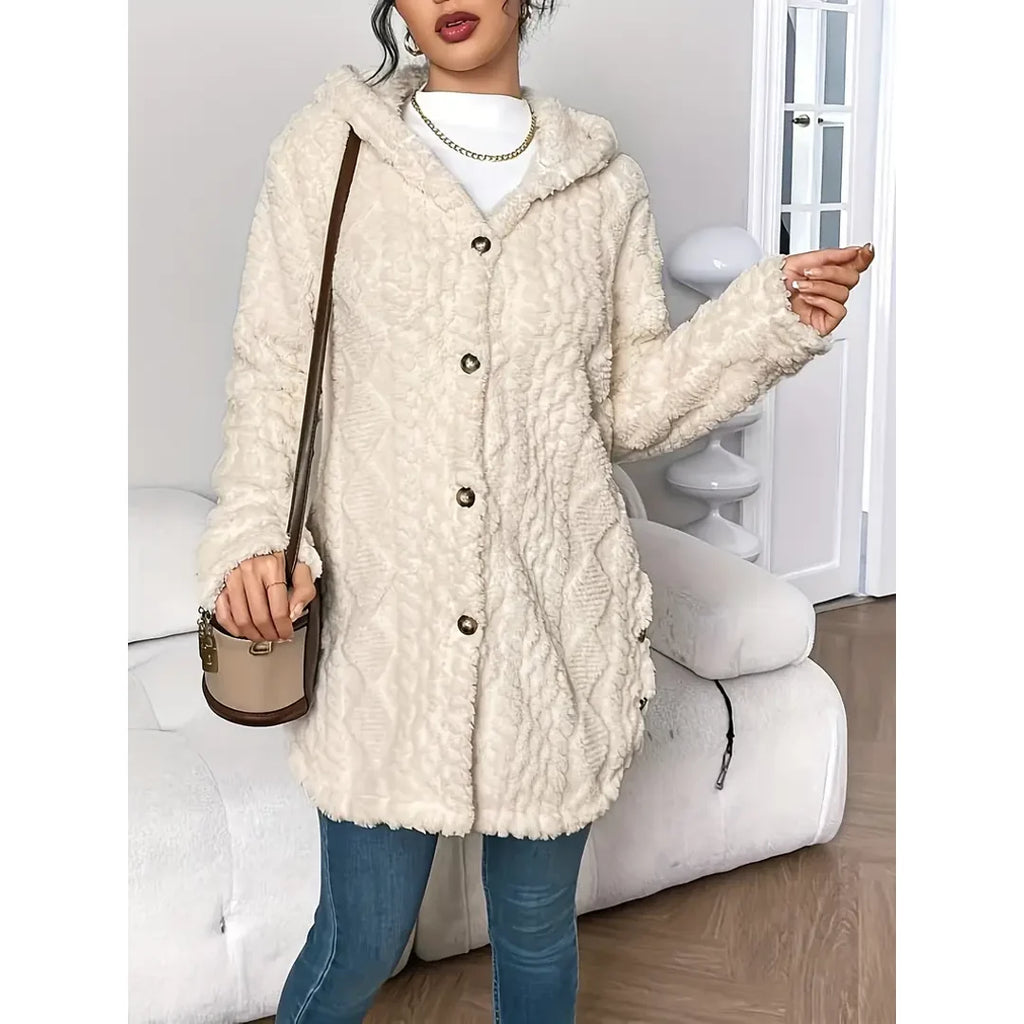 Woman wearing a beige hooded cable knit cardigan