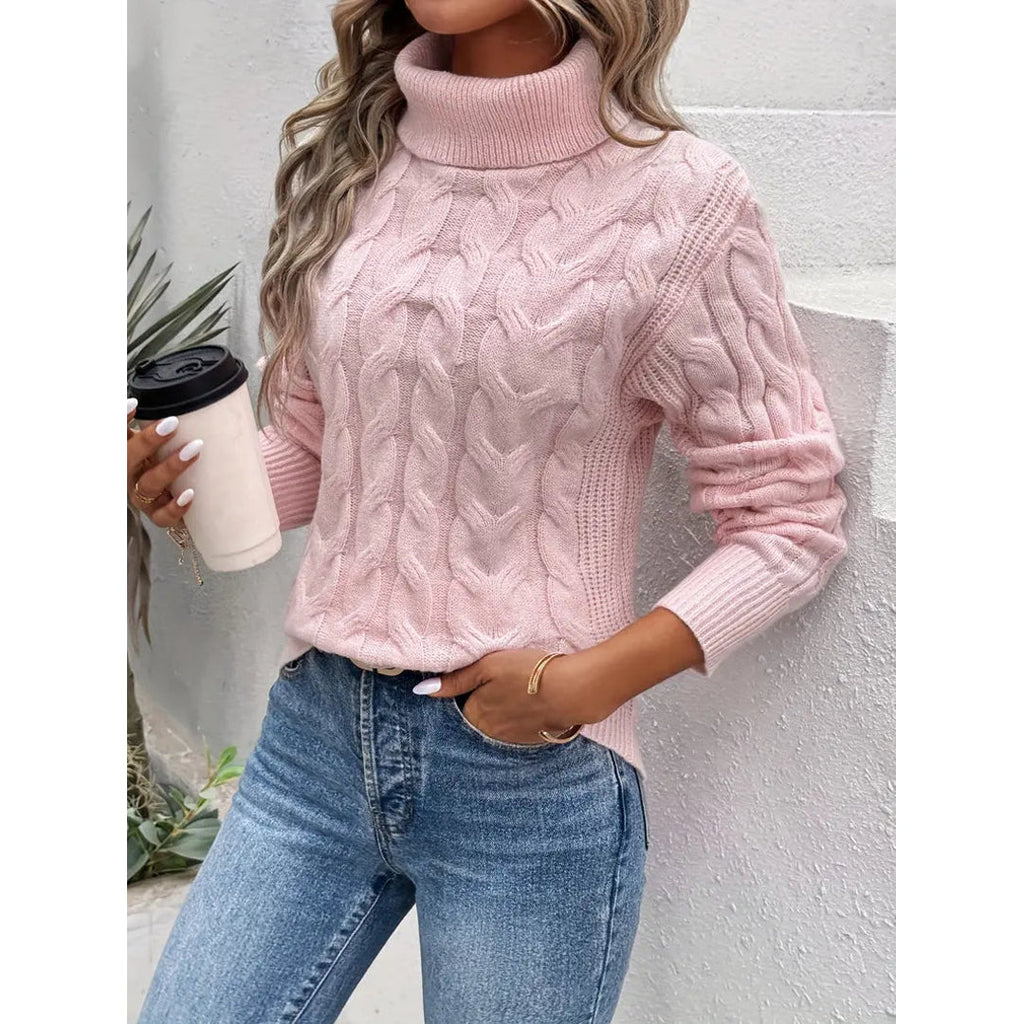 Women's pink cable knit turtleneck sweater with jeans