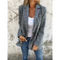 Woman wearing a grey check blazer with jeans