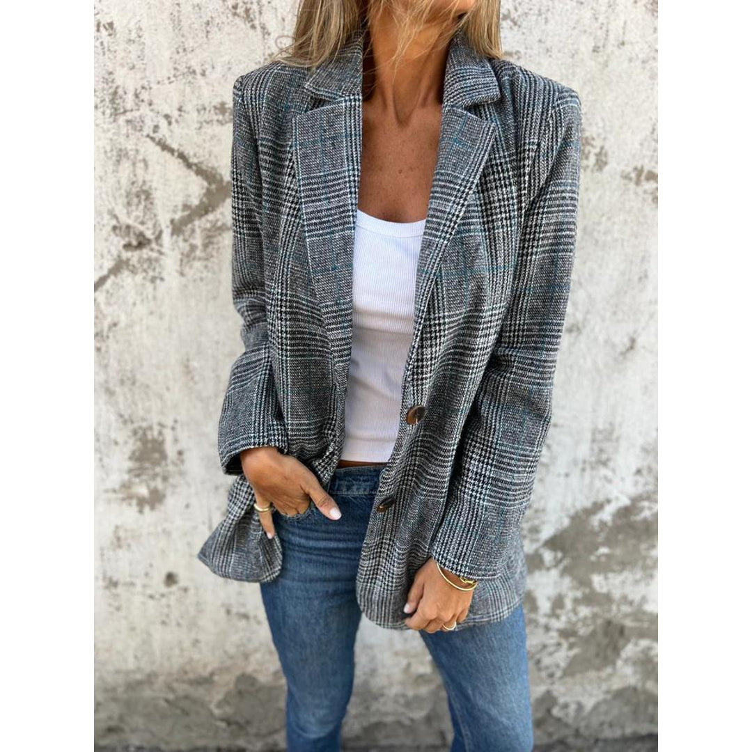 Woman wearing a grey check blazer with jeans