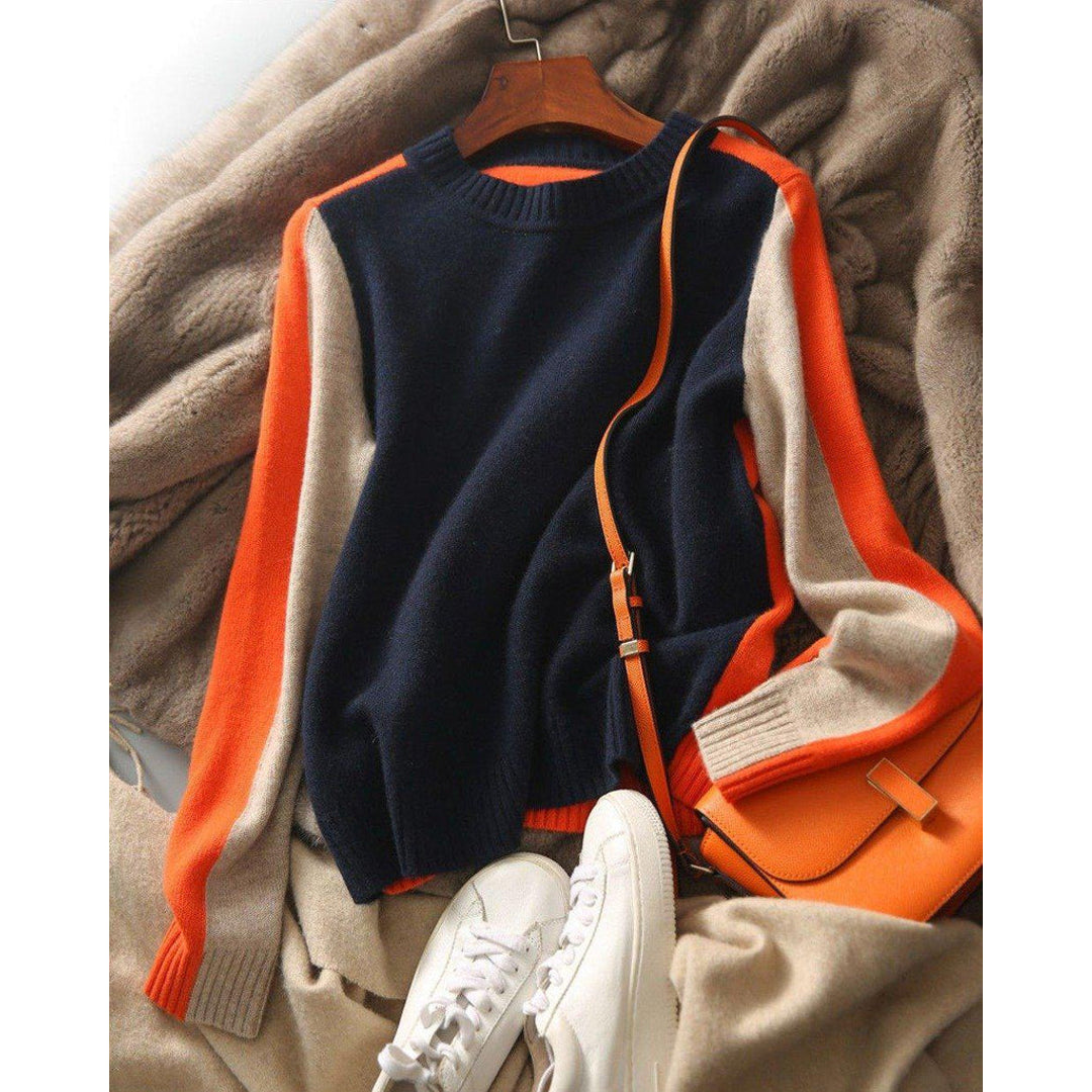 Women's colour block sweater styled with a bag and trainers