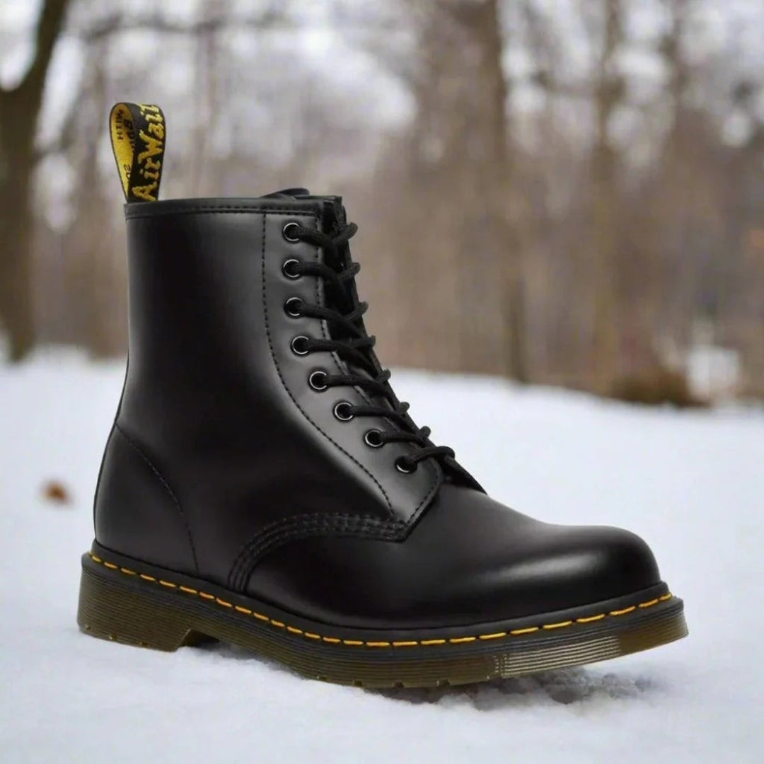 Women's black eight-eyelet lace-up boot in the snow