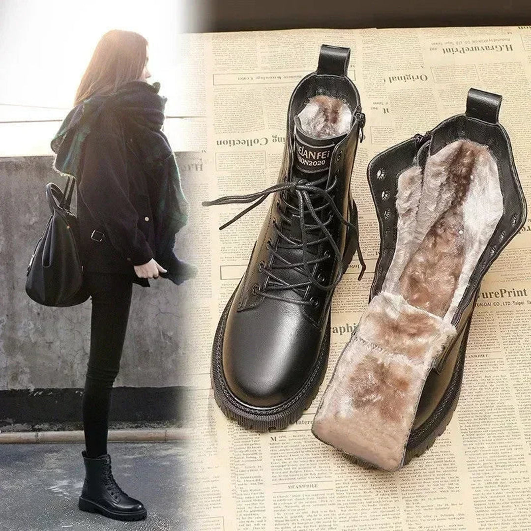 Woman in a black coat beside lined winter boots