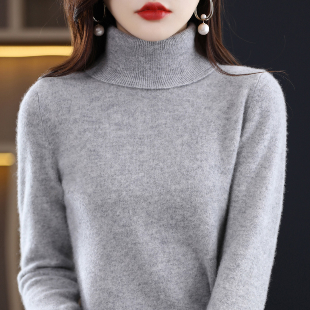 Woman wearing a grey turtleneck sweater