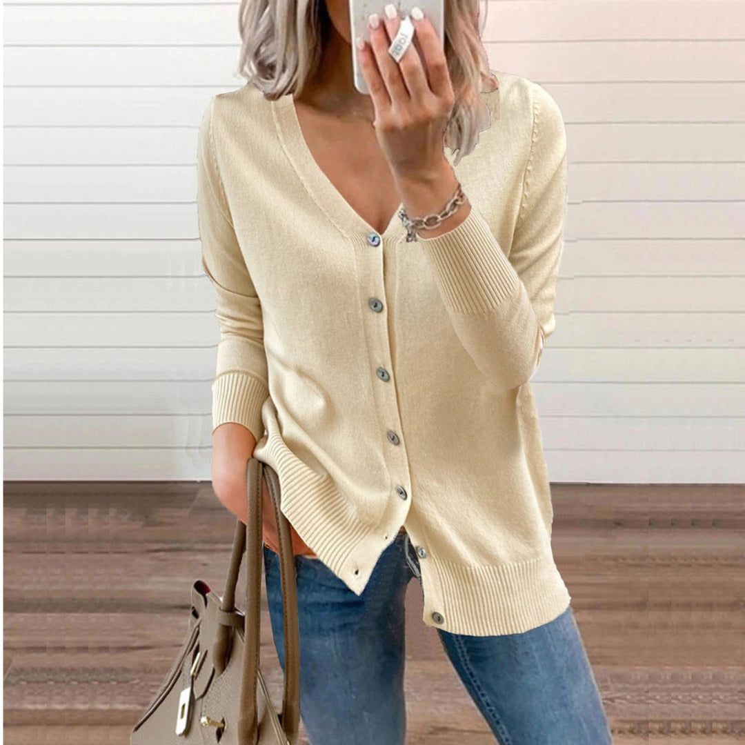 Woman wearing a beige button cardigan with jeans