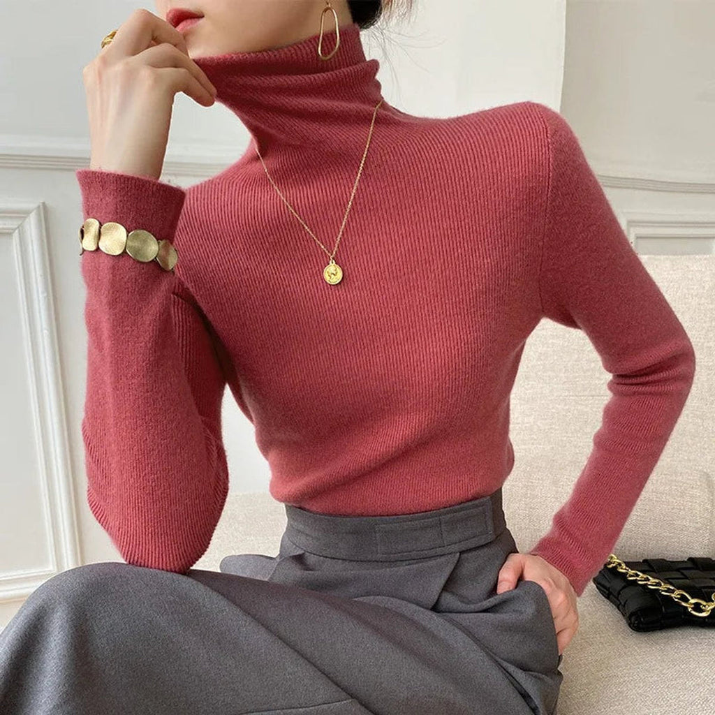Woman wearing a rosewood turtleneck with grey skirt