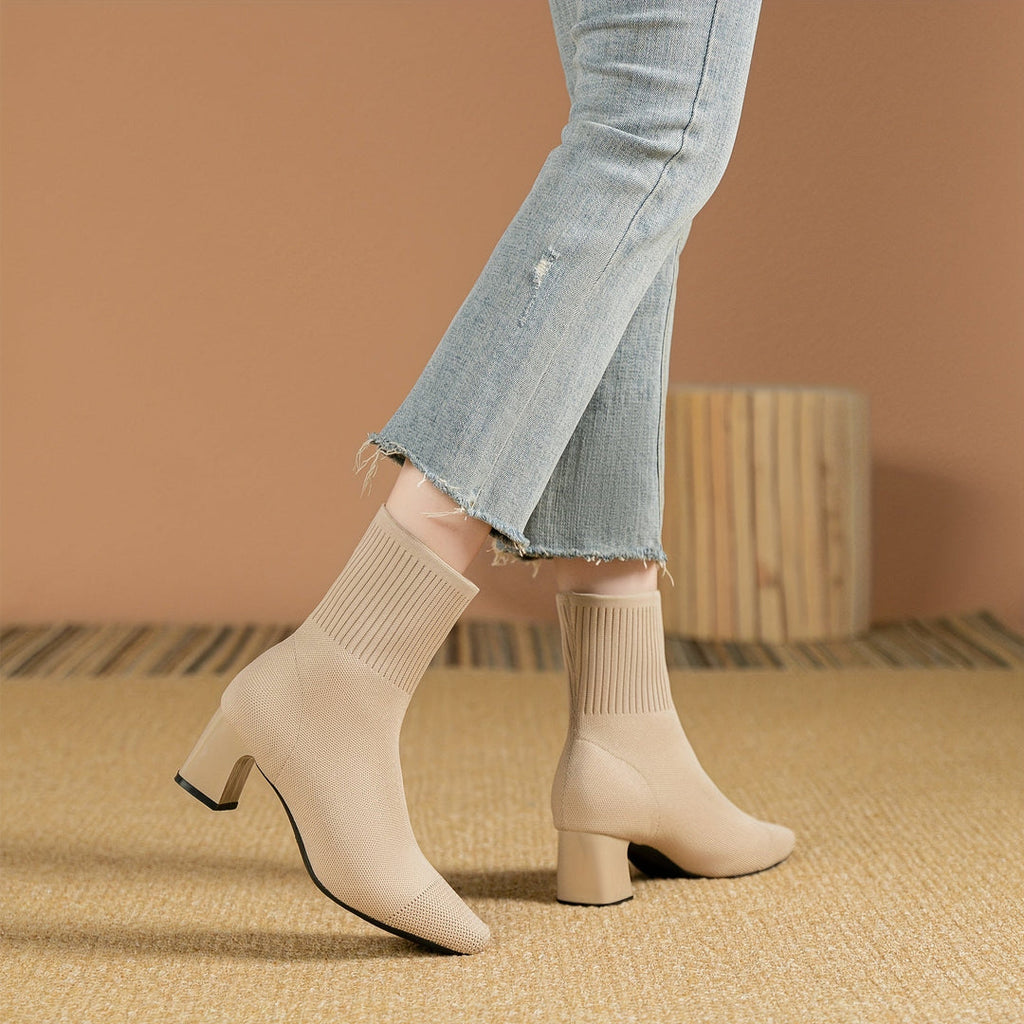 Woman wearing beige knit block heel boots