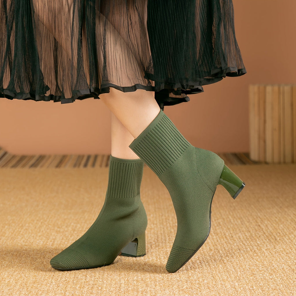 Woman wearing green knit block heel boots