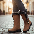 Women's camel lace-up winter boots with fluffy cuff on a cobbled street