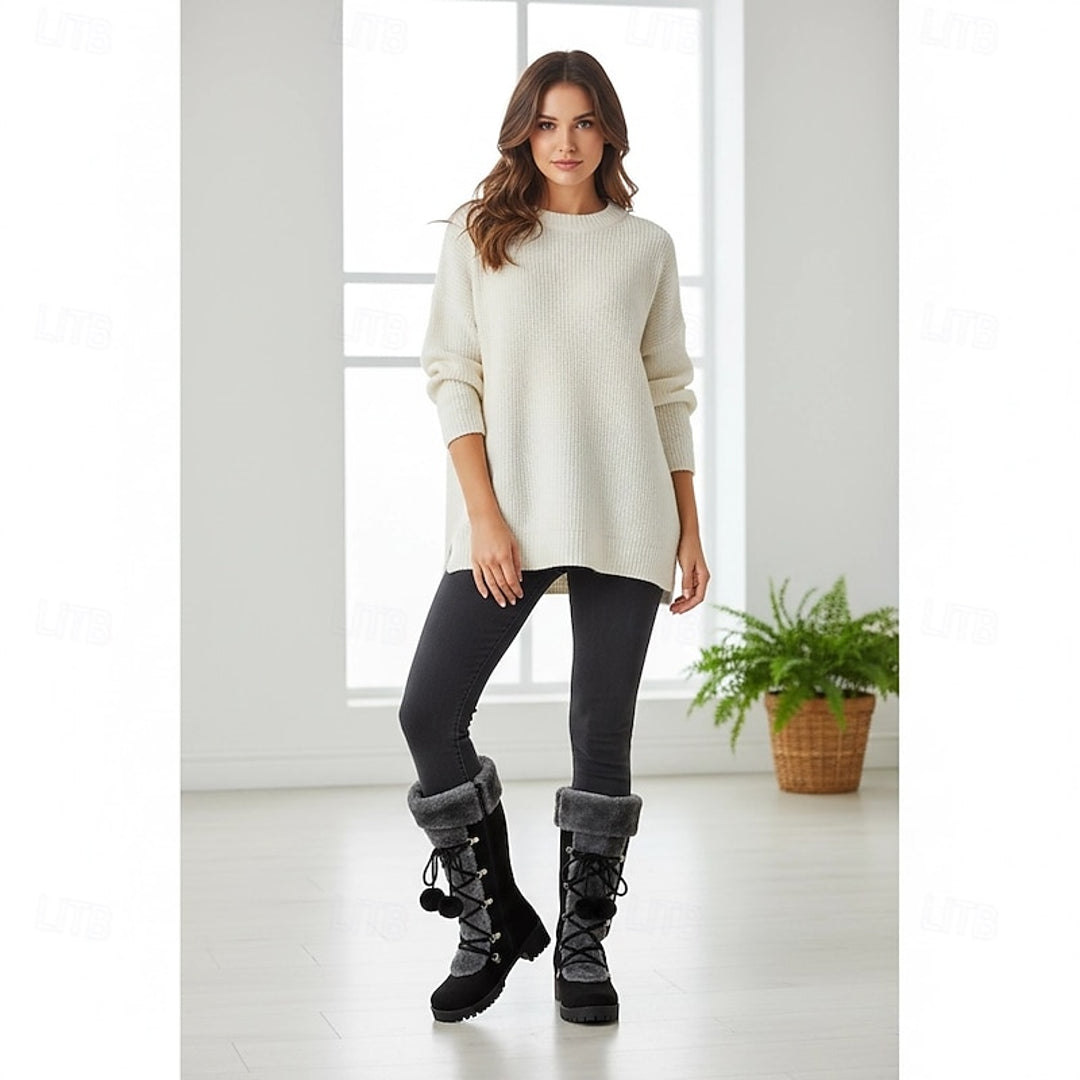 Woman wearing black lace-up winter boots indoors