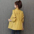 Woman wearing a yellow lightweight jacket – back view