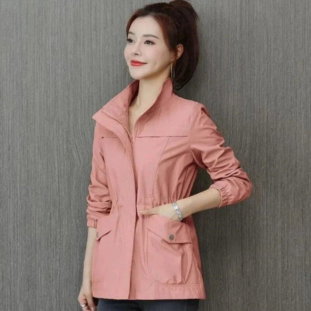 Woman wearing a pink jacket with stand collar