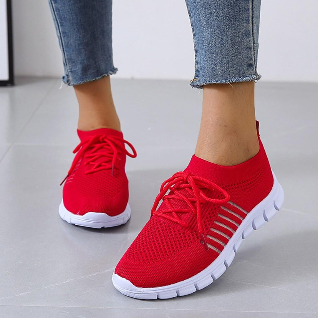 Woman wearing red lightweight knit sneakers