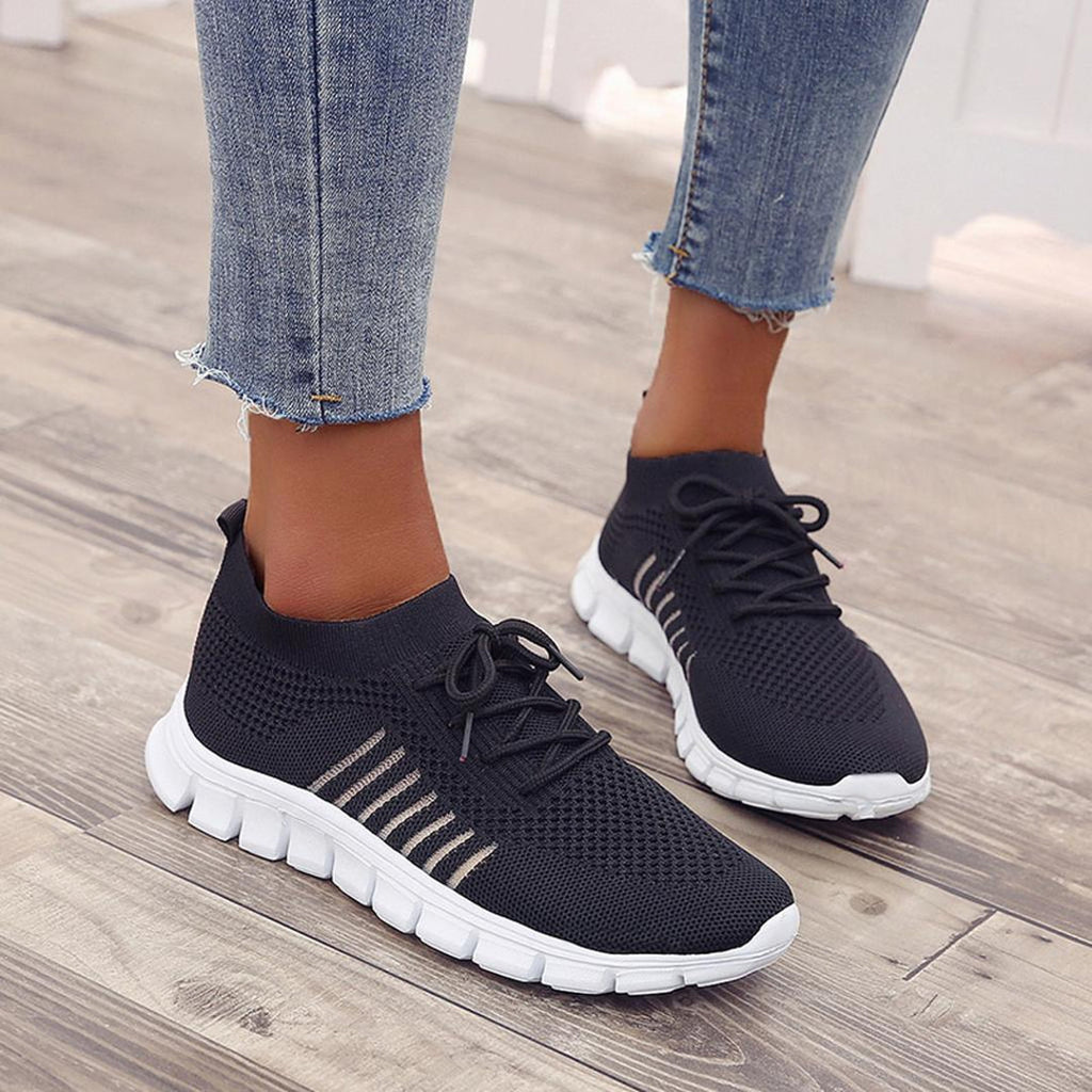 Woman wearing black knit lace-up sneakers