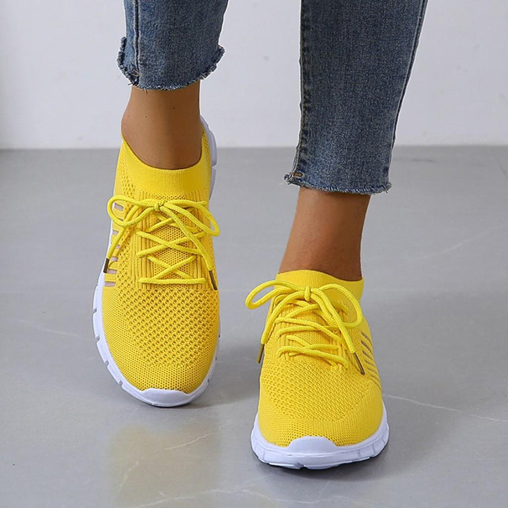 Woman wearing yellow knit lace-up sneakers