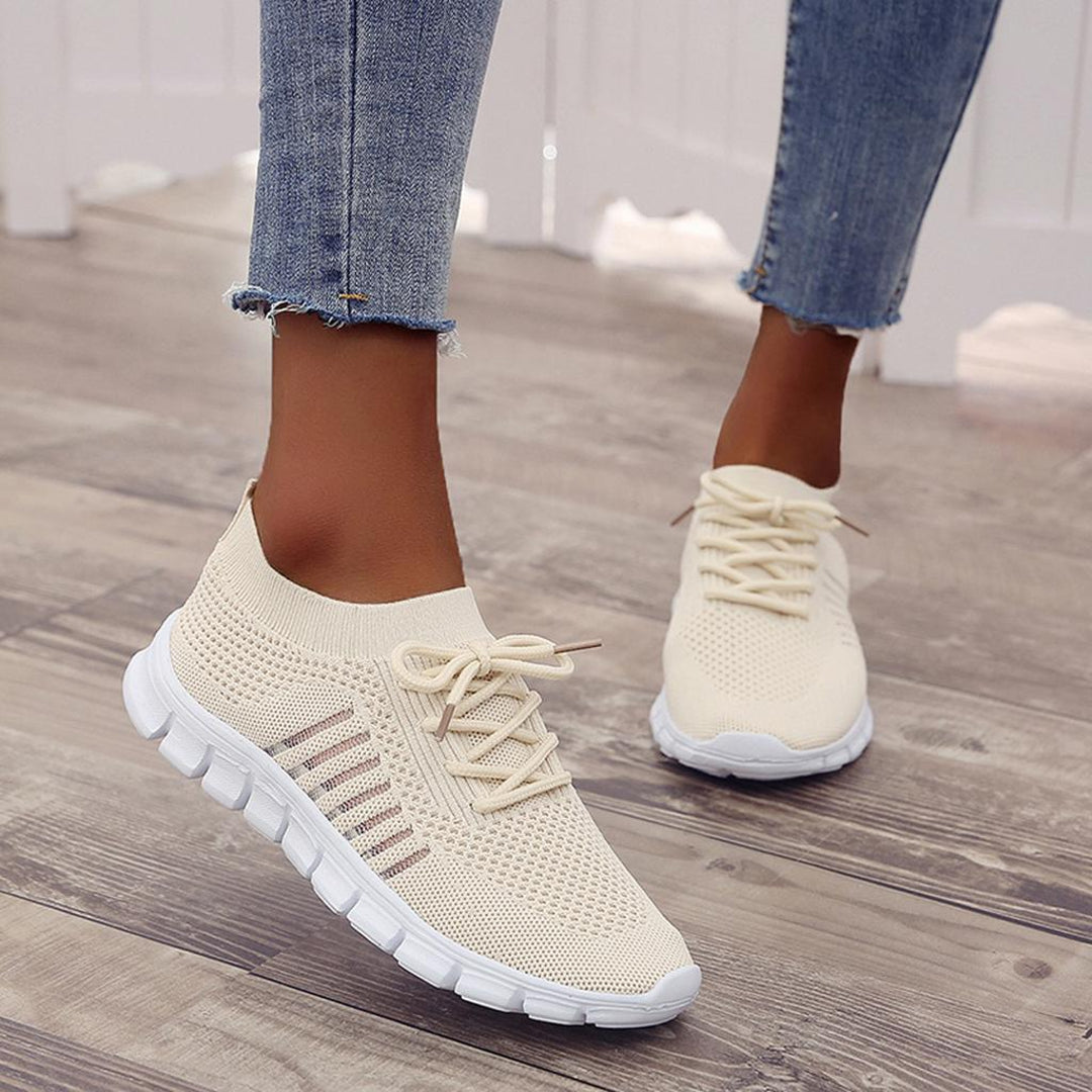 Woman wearing beige lightweight sneakers
