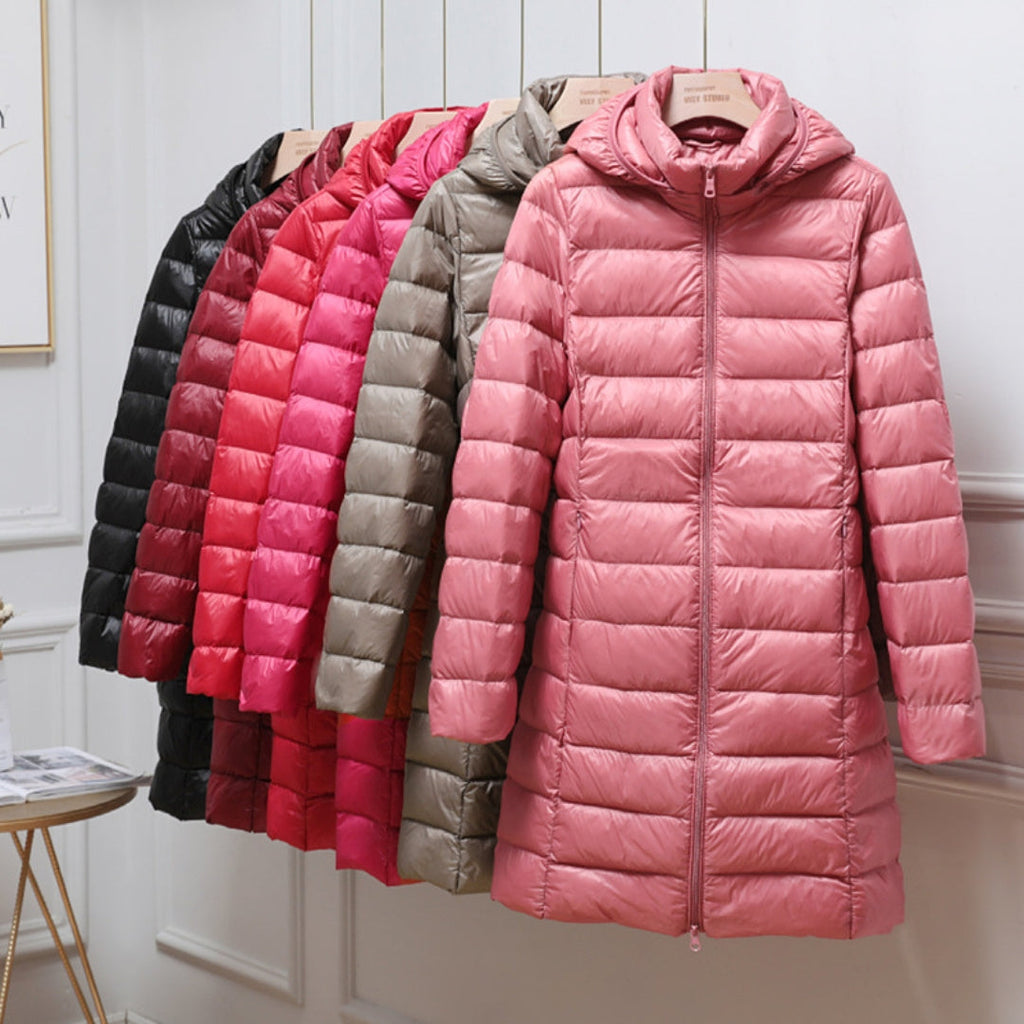 Long hooded puffer coats in several colours on a rail