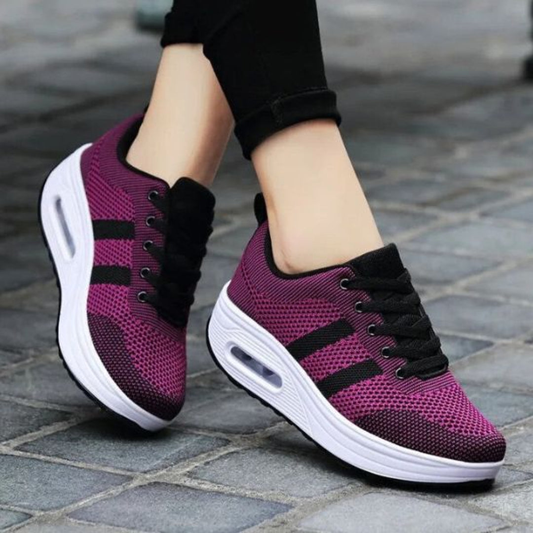 Woman wearing purple mesh lace-up sneakers