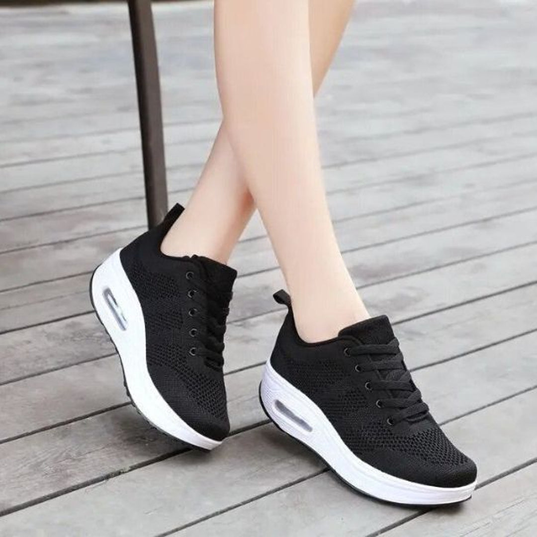 Woman wearing black mesh platform sneakers