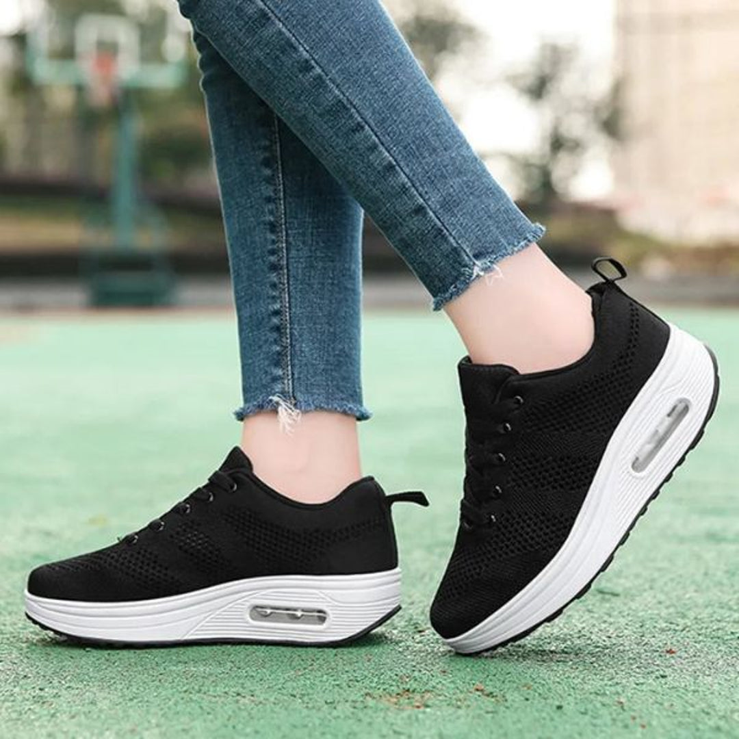 Black lace-up sneakers on artificial grass