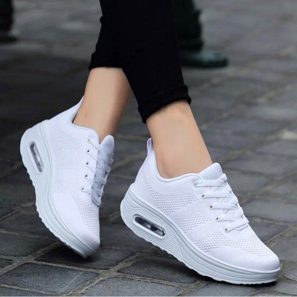 Woman wearing white mesh lace-up sneakers