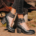 Woman wearing black multi-strap block heel ankle boots