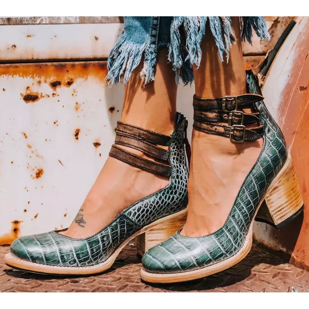 Green snake-effect ankle boots with buckle straps