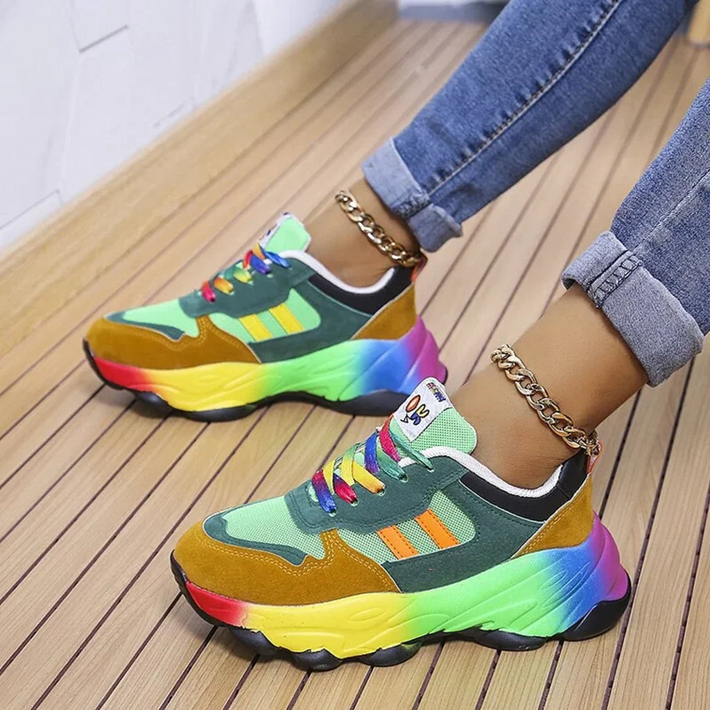 Woman wearing green rainbow chunky sneakers