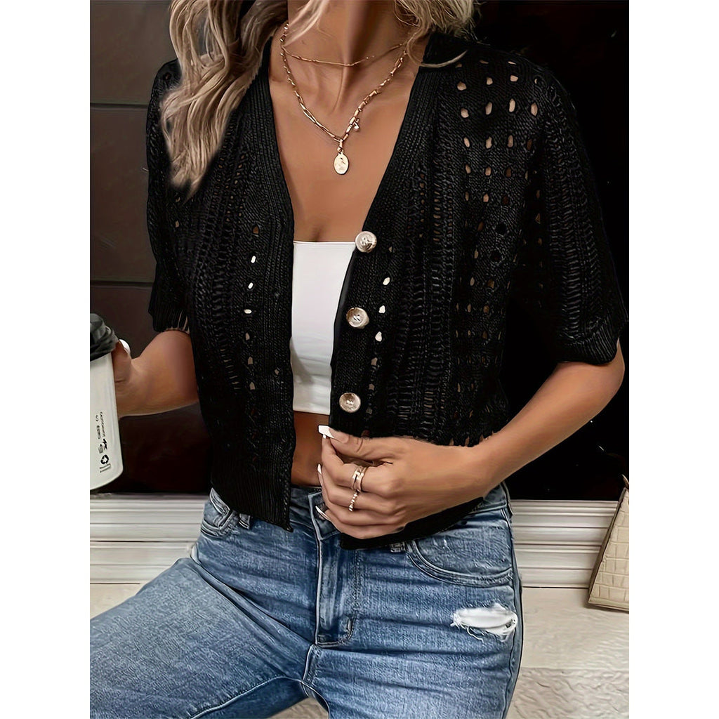 Women's black cropped open-knit cardigan with jeans