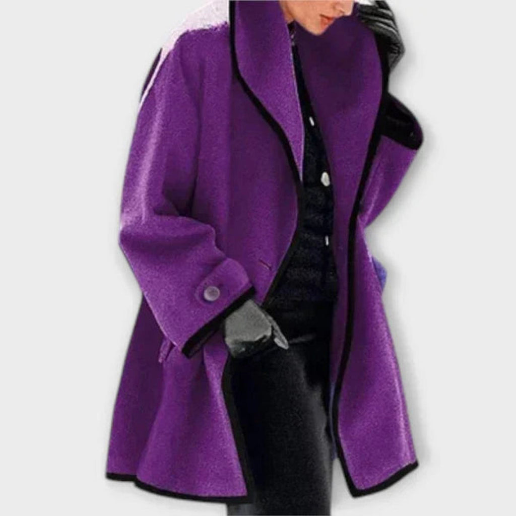 Woman wearing a purple oversized coat with black trim