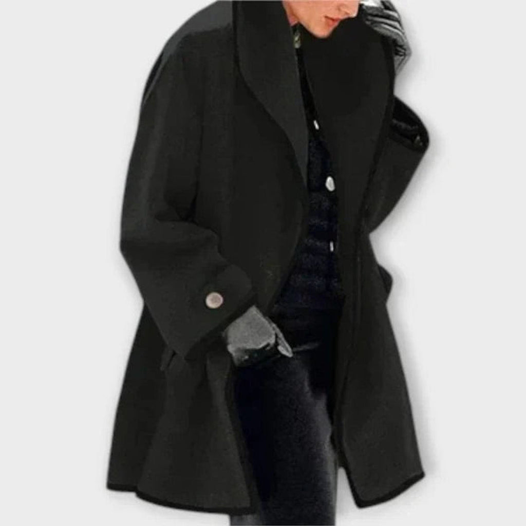 Woman wearing a black oversized A-line coat