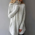 Woman wearing a grey oversized chunky knit turtleneck sweater
